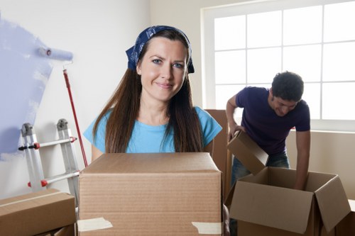Movers carrying furniture down narrow stairs